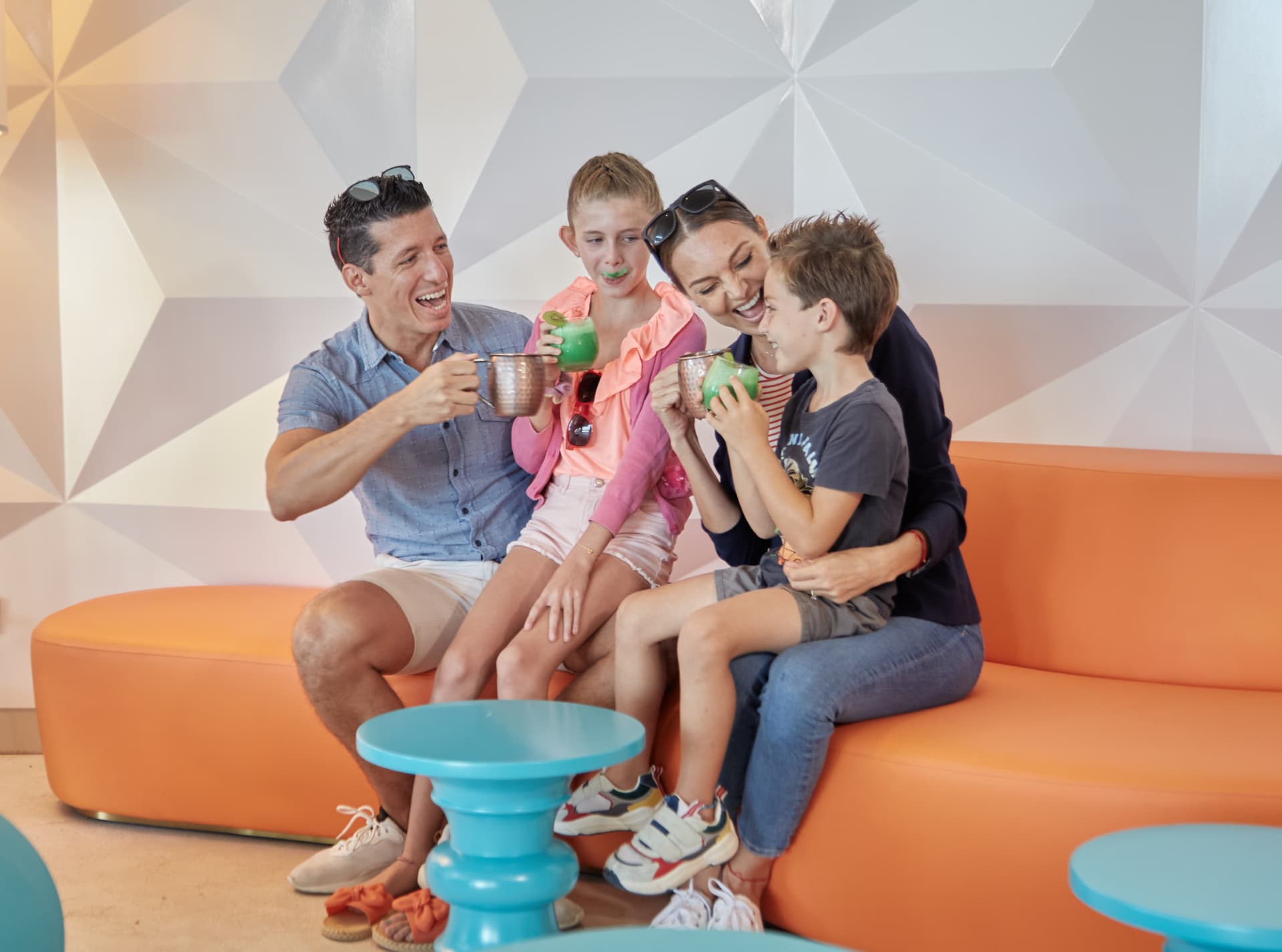 Family relaxing with drinks in the resort lobby lounge